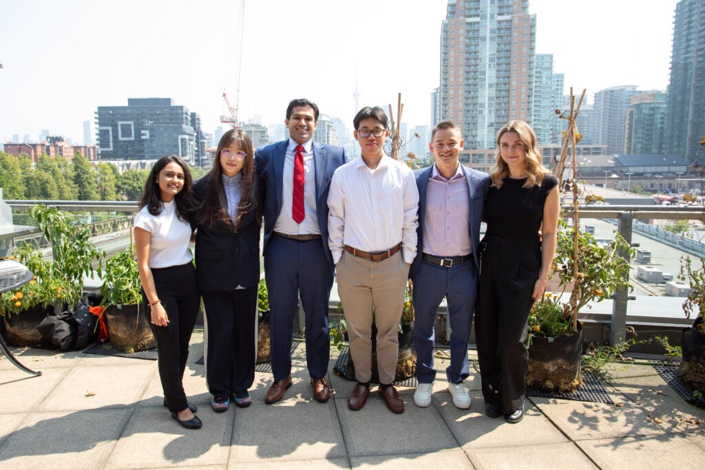 Group of interns Infront of Toronto cityscape