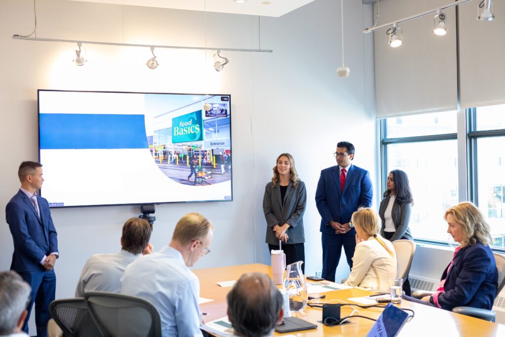 Group of interns presenting to ELT 