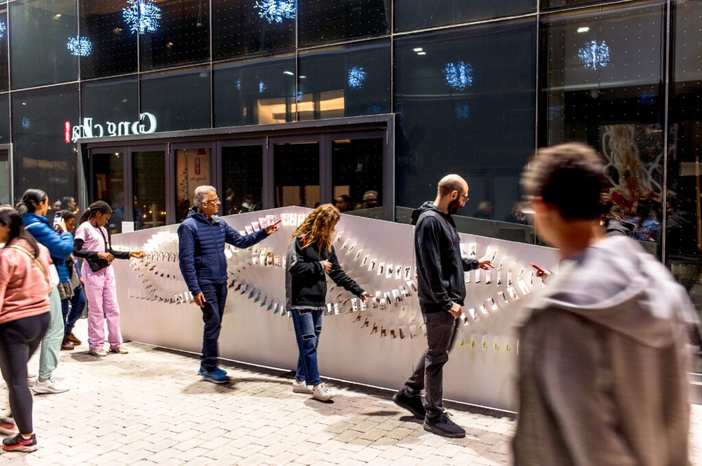 people interacting with art