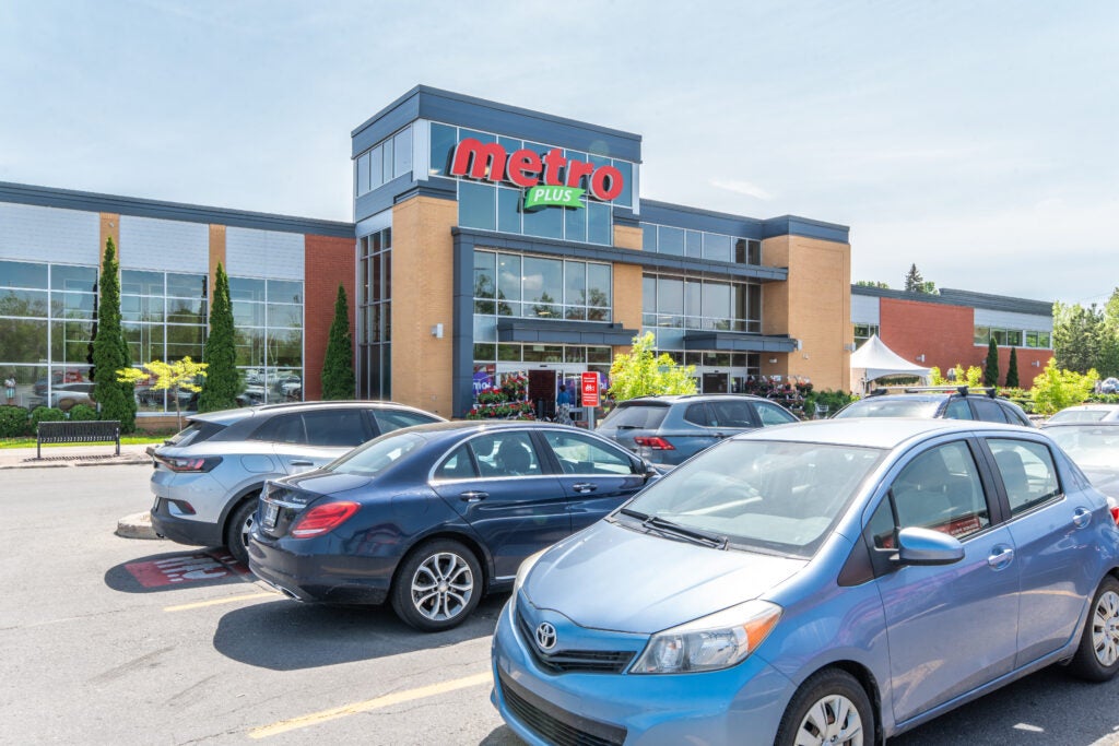 exterior of Metro Grocery Store with parked cars in the foreground