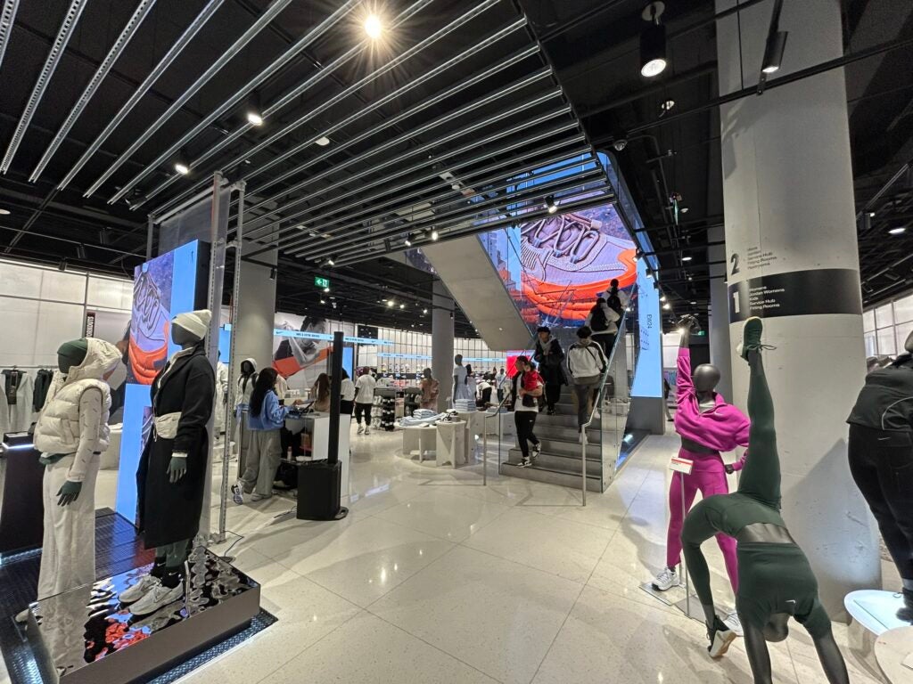 Interior of Nike at One Bloor East with people and merchandise