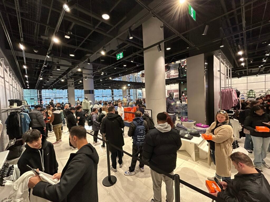 Interior of Nike at One Bloor East with people and merchandise