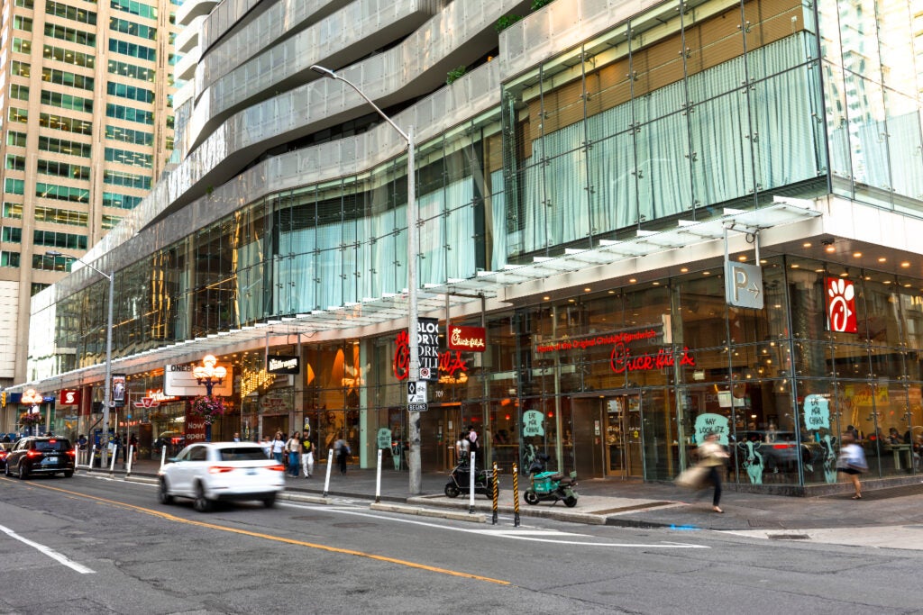 Chick Fil A facade at One Bloor East with cars and people passing by
