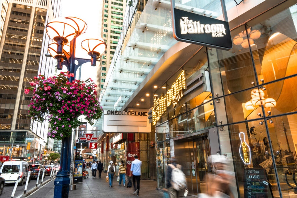 people walking by Ballroom Bowl at One Bloor East