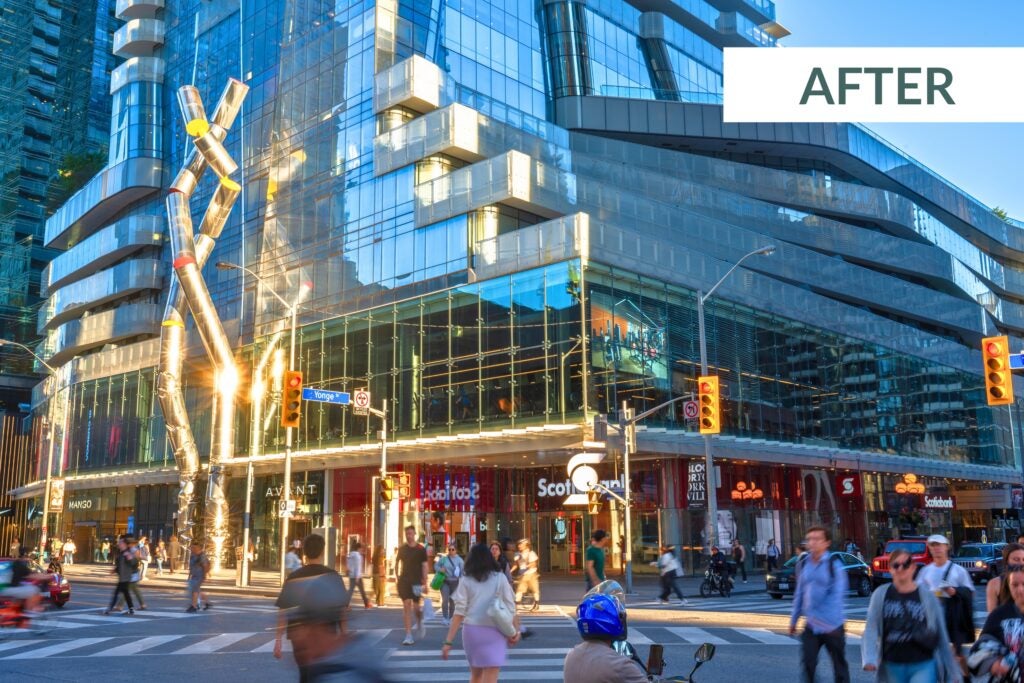 Corner of Yonge and Bloor with facade of building showing  New tanants including Scotiabank, Nike, Mango, Ballroom Bowl, and Avant with people and cars going through intersection